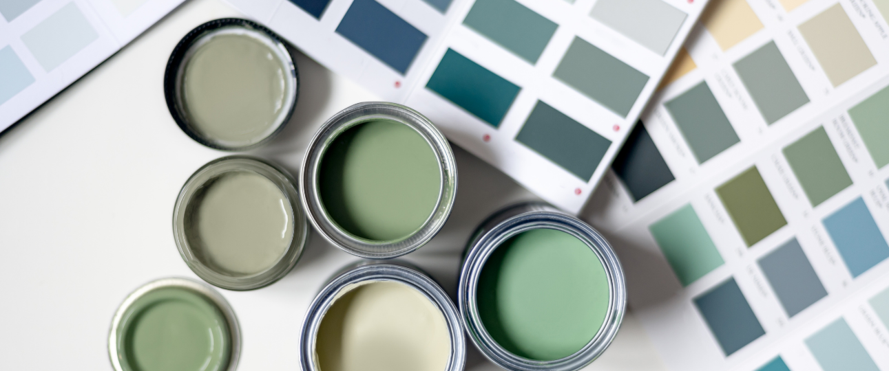 Pots of tester paint in different shades of green