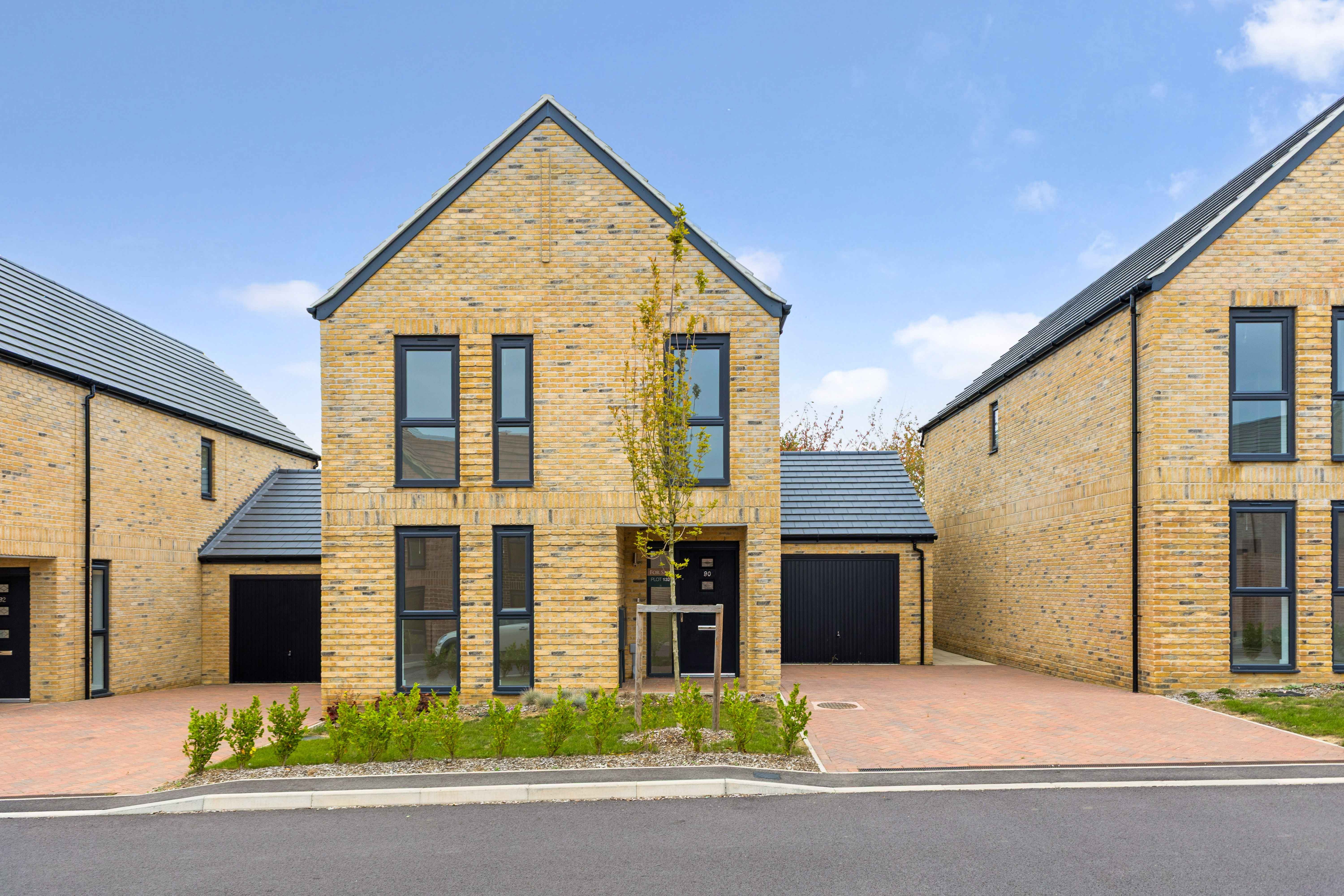 Modern brick home with driveway and garage in at a new-build development in Essex.