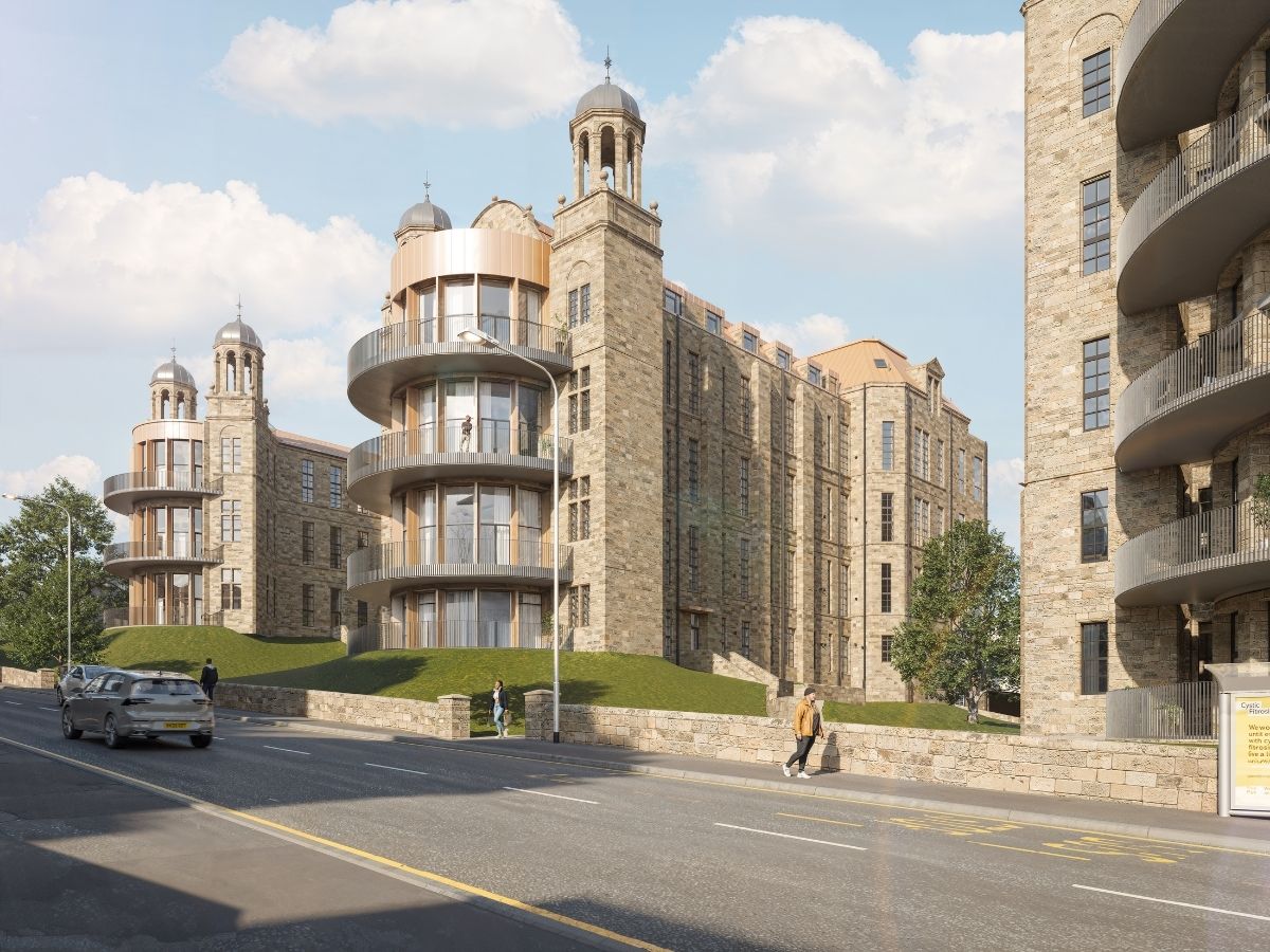 Wide view of The Nightingale apartment development featuring stone buildings, landscaped embankments and modern curved balconies.