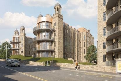 Wide view of The Nightingale apartment development featuring stone buildings, landscaped embankments and modern curved balconies.