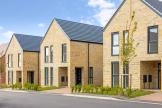 Modern brick houses with pitched roofs and large windows at the Southfield housing development in Essex.