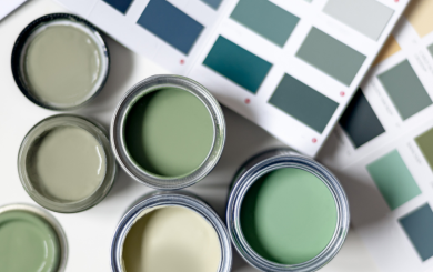 Pots of tester paint in different shades of green