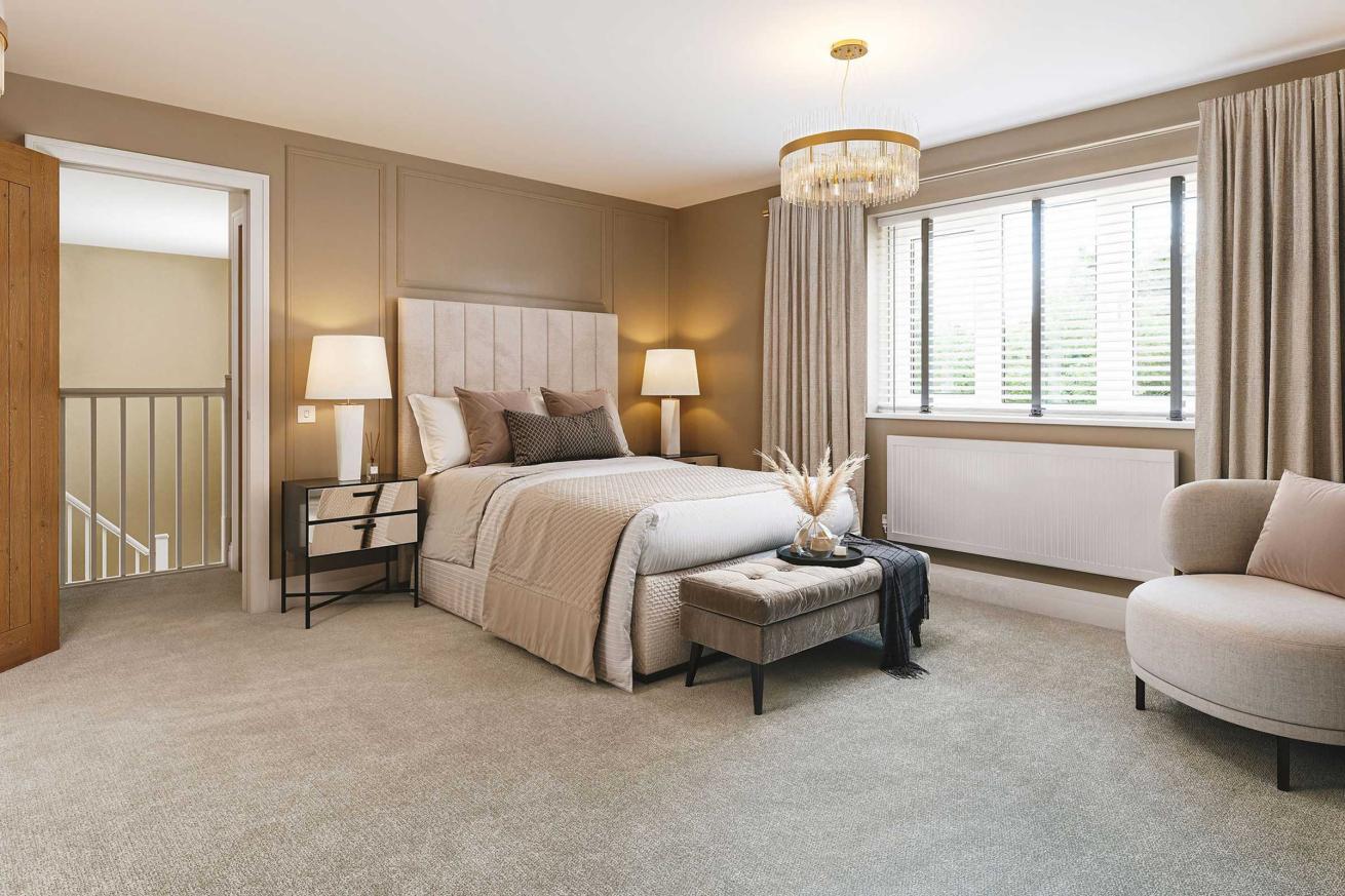  Stylish bedroom featuring a bed with white bedding and navy accents, a dark floral feature wall, two bedside tables with matching lamps, a cushioned bench at the foot of the bed, and a large window with beige curtains.