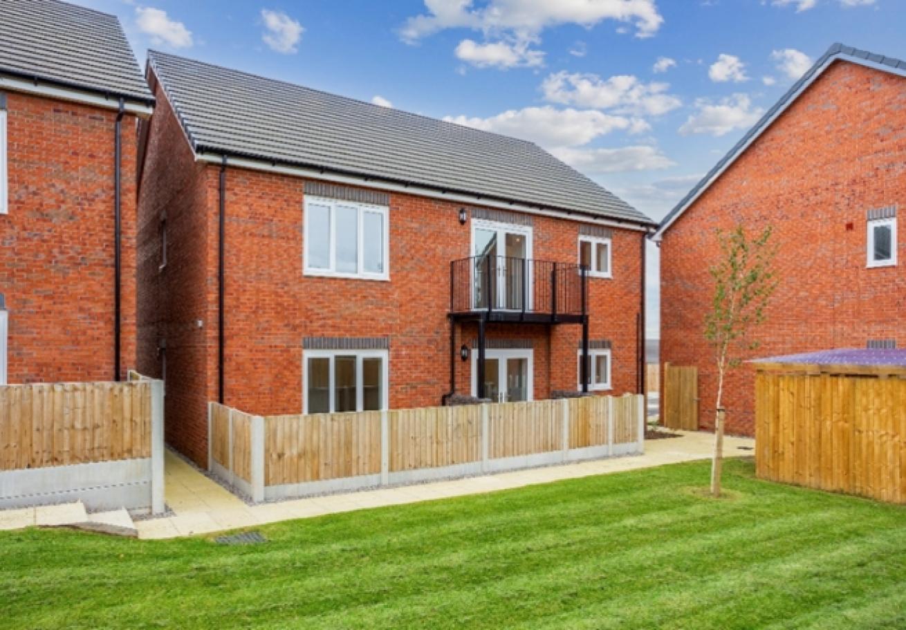 Exterior image of the back of plot 12 of The Willows showing the communal back garden area 