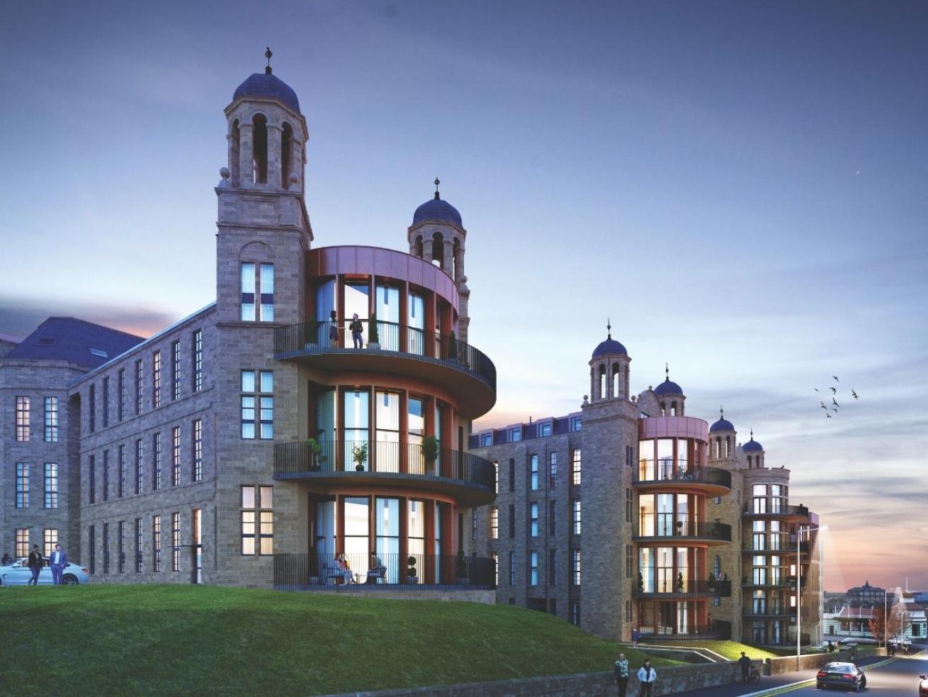 Twilight view of The Nightingale residential development with stone façades, curved balconies and illuminated apartments.