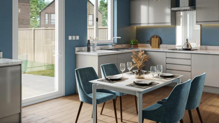 A large open plan kitchen and dining area with patio doors leading into the garden