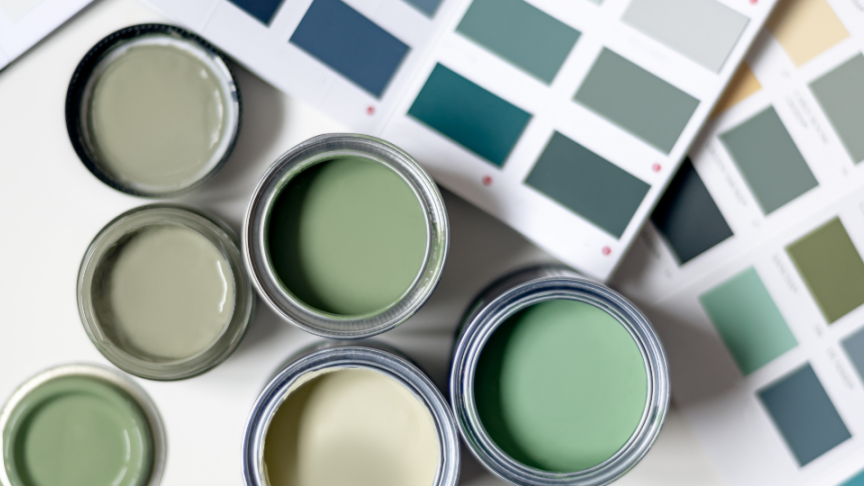 Pots of tester paint in different shades of green