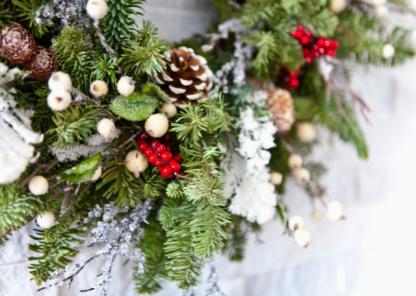 A close up of a Christmas wreath on a stone wall