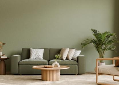 ere’s a short alt text for the image:  "Modern living room with green sofa, wooden coffee table, armchair, and large potted plant against a green wall