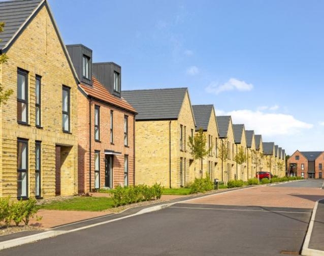 Southfields new-build development street view with rows of modern brick houses and landscaped front gardens.